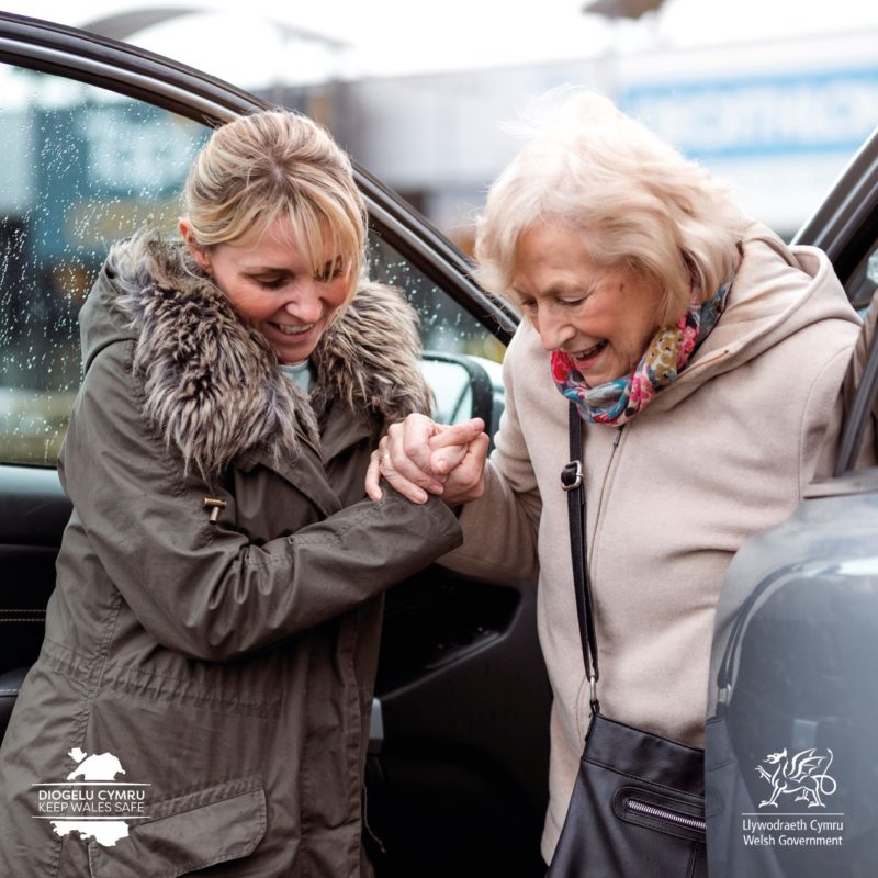 Welsh Government image of a carer helping a lady