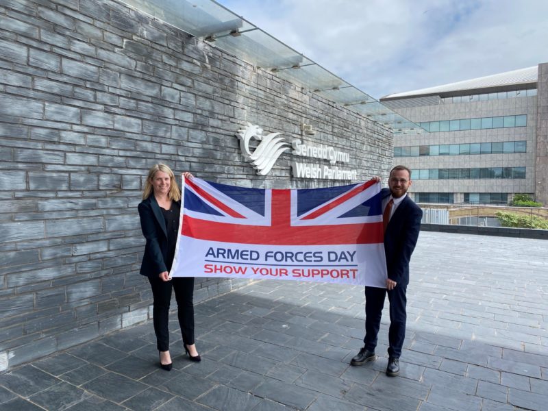 Hannah Blythyn MS and Jack Sargeant MS holding an Armed Forces Day flag