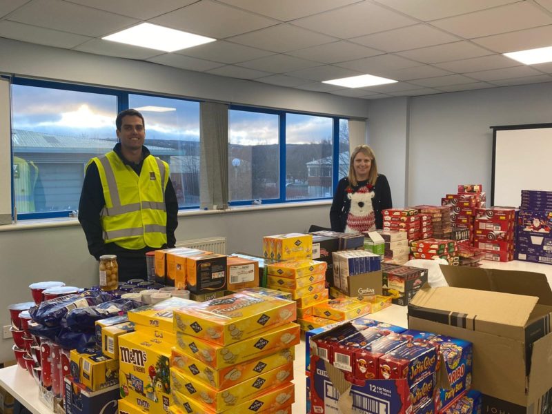 Hannah Blythyn MS with Patrick Roberts, Group Operations Director for Polyroof, with some of the donations already collected.